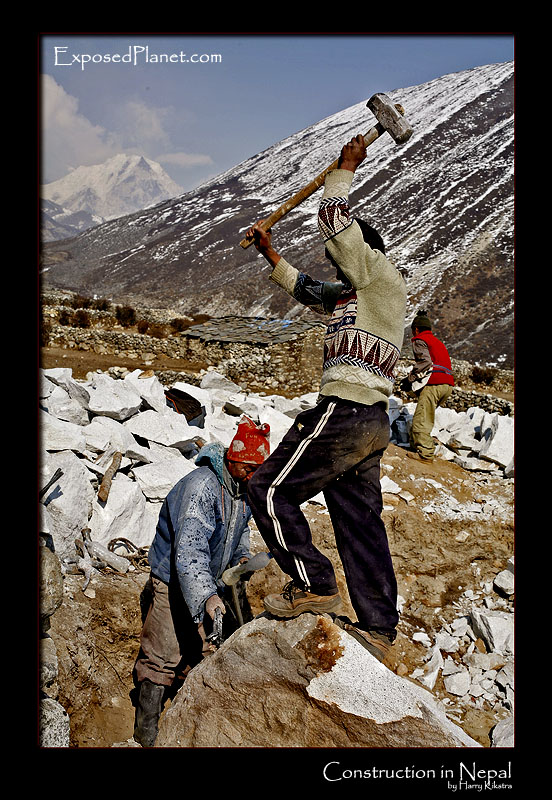 Construction in Nepal: men crushing rocks