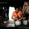 Young woman cleaning fish, Rio Napo, Peru