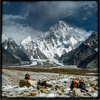 Porters on Baltoro Glacier with K2 in back