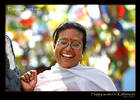 Happy Woman in Kathmandu with prayer flags